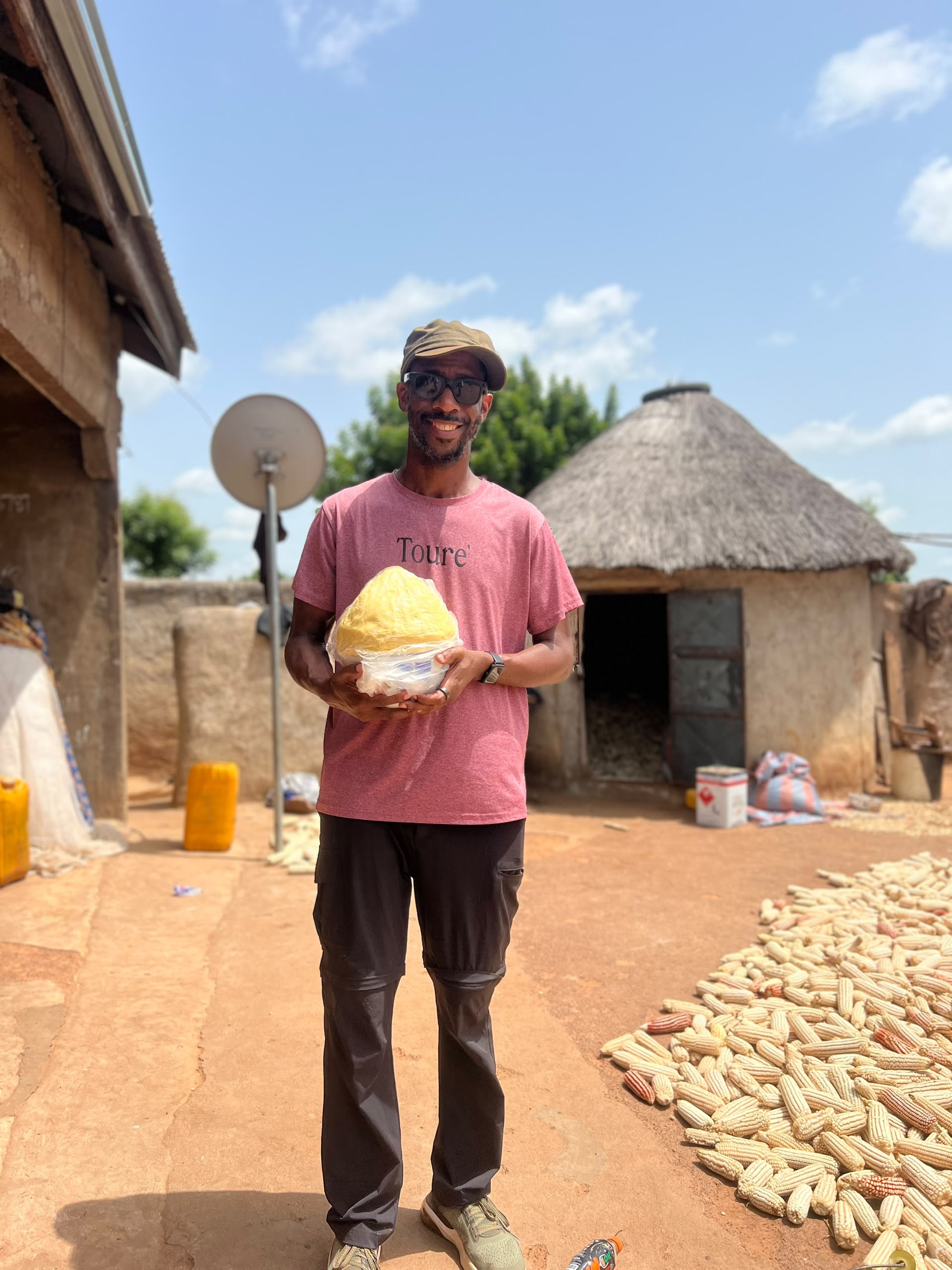 Jerome Fleming holding a ball of shea butter in Ghana